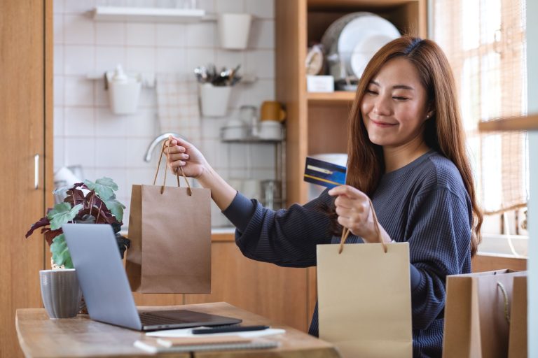 woman-using-laptop-computer-credit-card-online-shopping-home